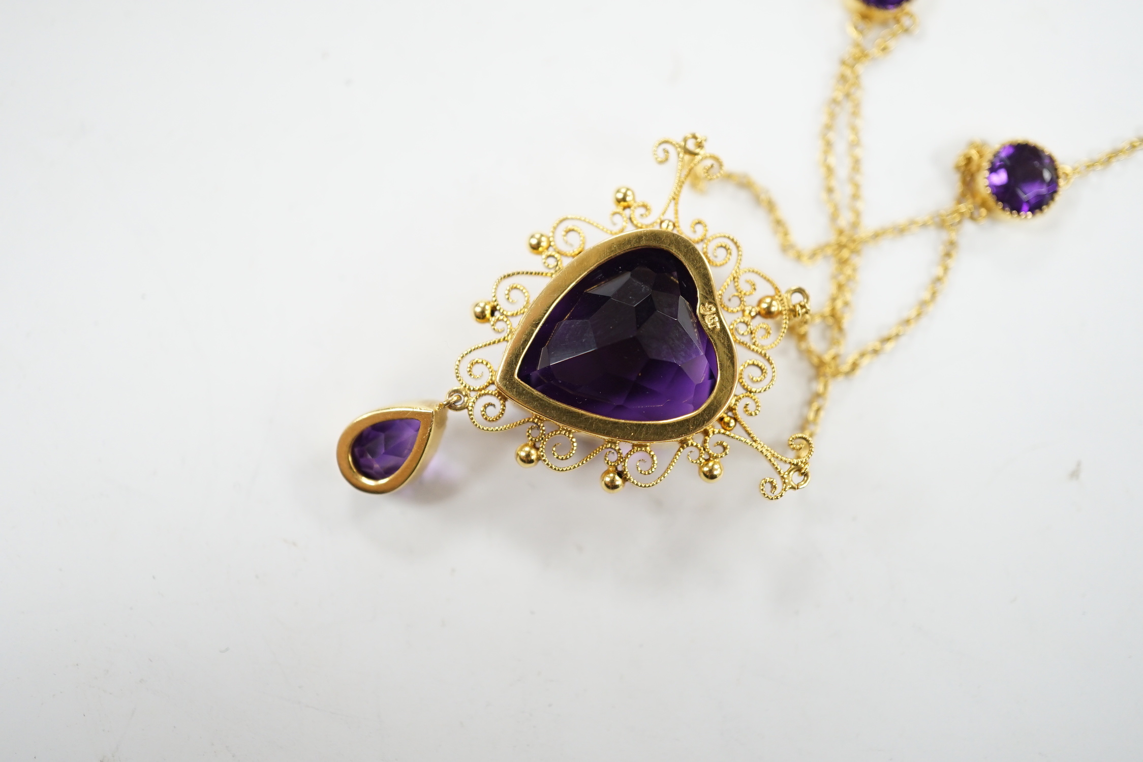 A Victorian style 9ct and four stone amethyst drop pendant necklace, the pendant set with heart shaped central stone and pear cut drop, overall 46cm, gross weight 8 grams.
